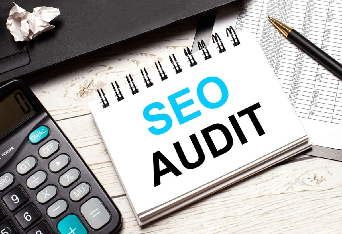 a pen and a notebook with the text SEO AUDIT Seo Consulting Kenya